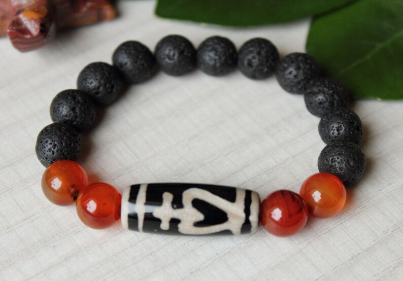Amulet of wealth and protection.Luck bracelet of Bead Dzi a vessel of abundance and 10mm sardonyx lava beads.Magic bracelet of gemstones.