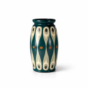 May include: A teal ceramic vase with a repeating pattern of white, grey, and black teardrop shapes. The vase also features small orange dots and a dark green rim. The vase is approximately 20 cm tall.