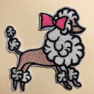 May include: Embroidered patch of a white poodle with a pink bow. The poodle is standing on its hind legs with its tail curled up. The patch is made of felt and has a white outline.