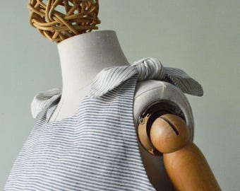STRIPED LINEN TOP: Light blue and cream linen top. A-line neckline with removable bows on the shoulders.