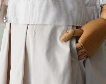 ALABASTRO Pleated Skirt. This item is handmade from stretch gabardine fabric. Solid color.