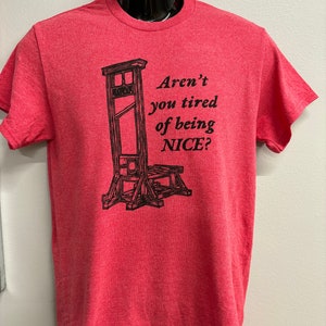 May include: Red t-shirt with a black graphic of a guillotine and the text "Aren't you tired of being NICE?"