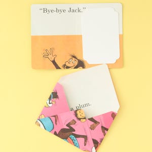 May include: A rectangular card with the text Bye-bye Jack and an illustration of a monkey waving, paired with a pink envelope featuring a repeating monkey pattern and a white insert card with the text a plum printed on the bottom edge.
