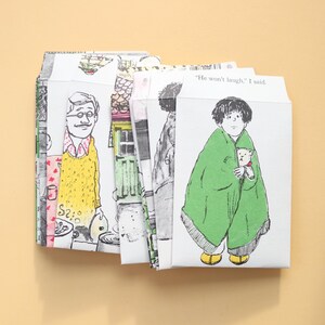 May include: A collection of illustrated paper envelopes with charming drawings. One envelope shows a child wrapped in a green blanket, holding a teddy bear. Another depicts a man in a yellow sweater. Text on one envelope reads, "He won't laugh," I said."