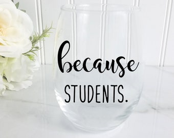 May include: Clear glass wine glass with the text "because students." printed in black.