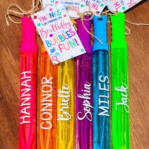 May include: Six colorful bubble wands with names: Hannah, Connor, Brielle, Sophia, Miles, and Jack. Each wand is a different color, with a matching cap. A tag reads "Thanks for making my birthday bubbles of fun!"