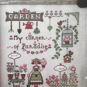 May include: Cross stitch pattern featuring a garden scene with a girl holding a shovel, a birdhouse, a birdcage, and a sign that reads "GARDEN My corner of Paradise". The pattern is 160 x 186 stitches.