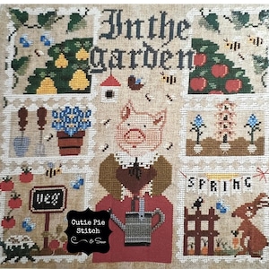 May include: Cross stitch pattern featuring a pig in a garden with the text "In the Garden" and "Spring". The pattern includes a variety of garden elements, such as flowers, vegetables, and a birdhouse. The pattern is designed by Cutie Pie Stitch & Sew.