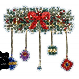 May include: A beaded Christmas wreath with a red bow and hanging ornaments. The ornaments are purple, green, red, and blue. The wreath is surrounded by a white background.