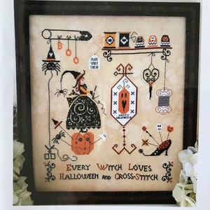 May include: A cross-stitch pattern featuring a witch sewing with a pumpkin, spider, and other Halloween-themed imagery. The text reads "Every Witch Loves Halloween and Cross-Stitch".