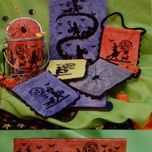 May include: A set of Halloween-themed embroidered towels featuring a black silhouette of trick-or-treaters carrying pumpkins and a cat. The towels are in various sizes and colors, including purple, blue, yellow, and orange.