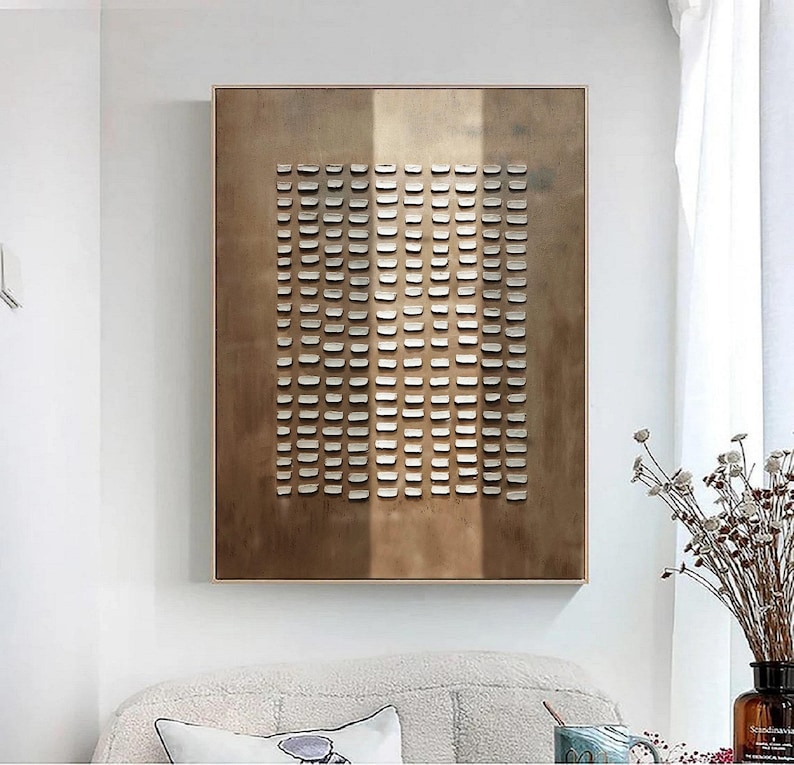 May include: Abstract wall art featuring a geometric pattern of white squares on a brown background. The squares are arranged in a grid pattern, creating a modern and minimalist design.