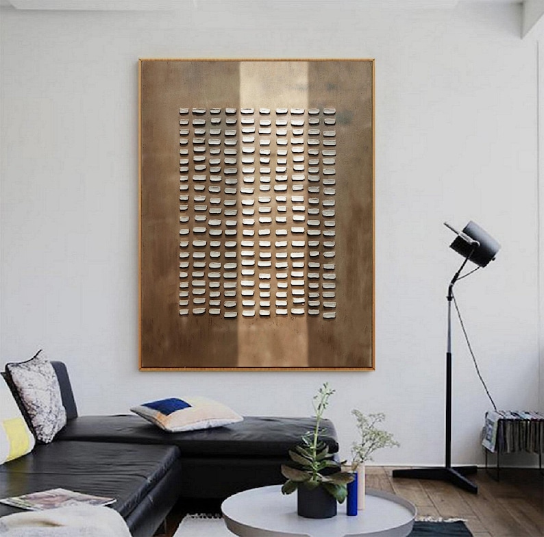 May include: A large abstract wall art piece with a brown background and a grid of white squares. The art is framed in a thin, light wood frame.