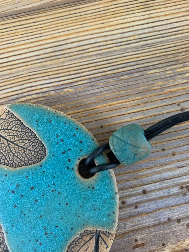 Free shipping Hand made ceramic ornament with leaf imprints and bead