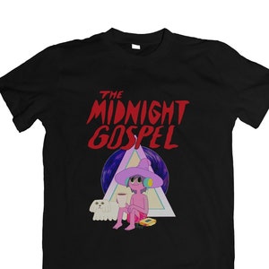 May include: Black t-shirt with a graphic print of a cartoon character wearing a purple hat and holding a cup. The text "THE MIDNIGHT GOSPEL" is printed in red above the character.