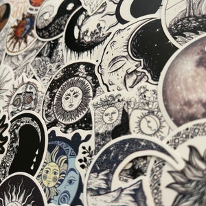 May include: A collection of black and white stickers featuring celestial and mystical designs. The stickers feature moons, stars, suns, and other celestial bodies, as well as abstract patterns and symbols. The stickers are perfect for adding a touch of whimsy and magic to any surface.