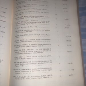 May include: A black and white page from a book with a list of names and titles. The page lists names of people and their positions in the government, along with the years they served. The page also includes the number of linear feet of documents for each person.