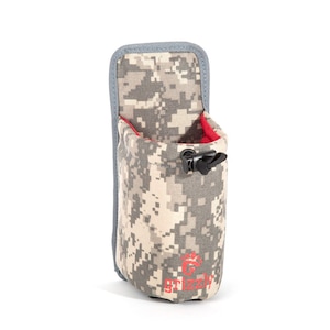 May include: A camouflage-patterned water bottle holder with a red drawstring and a black clip. The holder has a gray trim and the word "Grizzly" printed on the bottom in red.