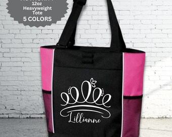 May include: Black tote bag with pink side panels and mesh side pockets. The bag features a white crown design with the name "Lillianne" in script. The bag has black handles and the text "PORT AUTHORITY 12oz Heavyweight Tote 5 COLORS".