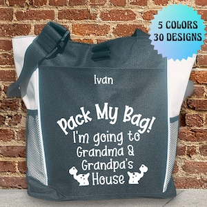 May include: A personalized dark blue tote bag with a white design that says "Pack My Bag! I'm going to Grandma & Grandpa's House". The bag has a white zippered pocket and a mesh side pocket. The bag is personalized with the name "Ivan".