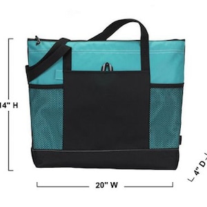 Op de afbeelding: Een teal en zwarte tote bag met een groot ritsvak aan de voorkant. De tas heeft mesh zijvakken en meet 35,5 cm hoog, 50,8 cm breed en 10,2 cm diep.