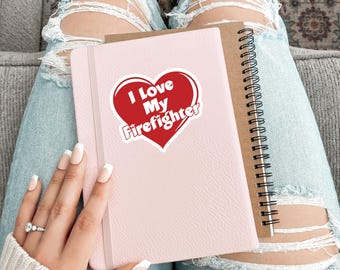 May include: A pink notebook with a red heart sticker that says "I Love My Firefighter".