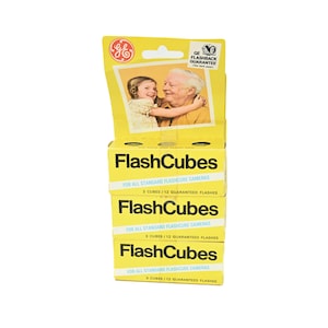 May include: Stacked boxes of GE FlashCubes for standard flashcube cameras. The boxes are yellow with black text, and feature a photo of a child and an older adult. Each box contains 3 cubes and 12 guaranteed flashes.