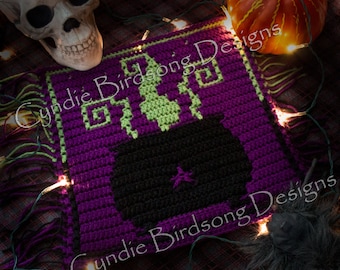 May include: A purple crocheted square with a black cauldron and green accents. The square has fringe around the edges and the text "Cynthie Birdsong Designs" is visible in the image.
