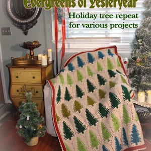 May include: A crocheted blanket with a repeating pattern of green and blue Christmas trees on an off-white background. The blanket has a red border and is draped over a chair. Text on the image reads "Evergreens of Yesteryear" and "Holiday tree repeat for various projects."