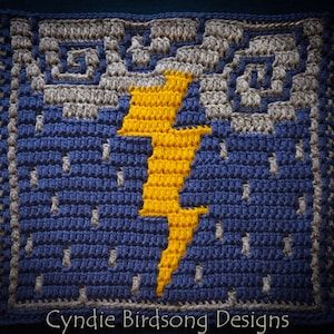 May include: A crocheted square featuring a yellow lightning bolt design on a blue background. The background has a pattern of grey raindrops. The square has a grey border and fringe on all sides. The text "Cynide Birdsong Designs" is at the bottom of the square.