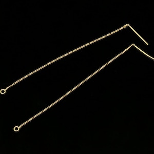 May include: A pair of gold chain earrings with a straight bar at the end of each chain.