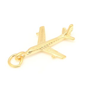 May include: A gold airplane charm with a loop for attaching to a necklace or bracelet.