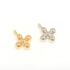 May include: Two metal cross charms, one gold and one silver, each with five round beads forming the cross shape.