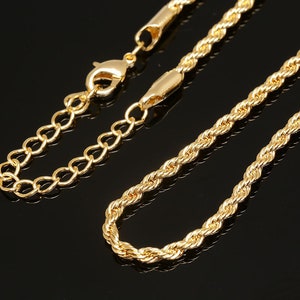 May include: A gold-tone chain necklace with a rope chain design and a lobster claw clasp.