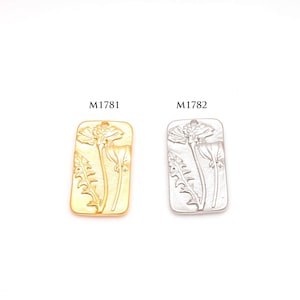 May include: Two rectangular pendants with a floral design. One is gold-colored, the other is silver-colored. Each pendant features a detailed relief of a flower with leaves and the text "M1781" and "M1782" above them.