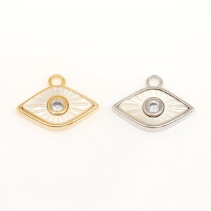 May include: Two gold and silver evil eye charms with a white enamel background and a clear rhinestone in the center.