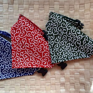 Puede incluir: Tres collares para mascotas en azul, rojo y verde, cada uno con un patr&oacute;n de remolino blanco. Los collares tienen hebillas de pl&aacute;stico negro y anillas en D de metal. Se muestran sobre una superficie tejida.