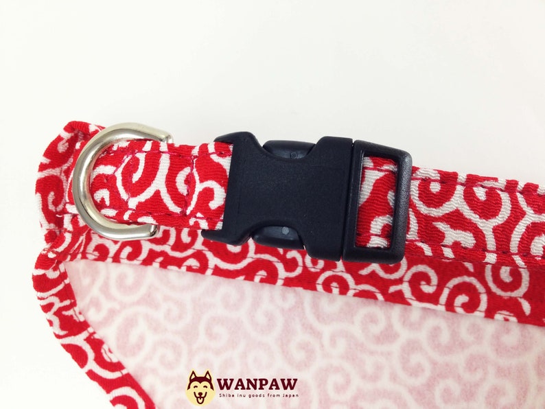 Puede incluir: Collar para perros con un patr&oacute;n de remolinos rojos y blancos, una hebilla de pl&aacute;stico negro y una anilla en D de metal plateado. El dise&ntilde;o del collar es un patr&oacute;n repetido. El logotipo de la marca "WANPAW" es visible.