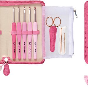 May include: A pink faux leather case with a zip closure holds a set of 10 pink crochet hooks, a pair of scissors, and two needles. The case has a tassel and a small charm.