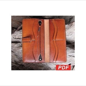 May include: Open, brown leather wallet with a zip closure and several card slots. The rectangular wallet has a tab closure. The interior features a lighter-coloured leather lining. The word "PDF" is visible in the bottom right corner.