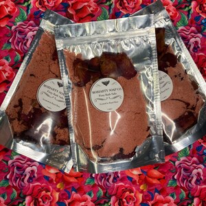May include: Three clear plastic bags filled with pink bath salts. The bags are labeled "Moriarty Soap Co. Fizzy Bath Salts Scented in Royal Rose".