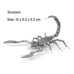May include: A silver metal model of a scorpion, assembled from individual pieces. The scorpion is posed with its tail raised and its claws extended. The model is 12 x 8.2 x 5.2 cm in size.