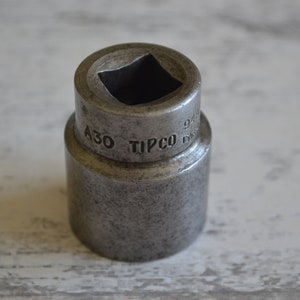 May include: A silver metal socket wrench with the text "A30 TIPCO" and "9/16" engraved on the side.
