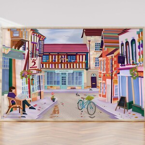 May include: A framed art print depicting a quaint European street scene. The artwork features colorful buildings, a bicycle, and a person reading a newspaper. The color palette includes shades of red, blue, and yellow, creating a vibrant and inviting atmosphere.