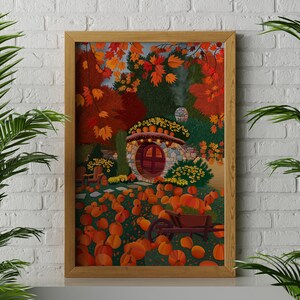 May include: A framed illustration of a stone cottage with a red door surrounded by autumn foliage and pumpkins. The cottage has a round window and a stone chimney. The pumpkins are scattered around the cottage and a wheelbarrow is in the foreground.