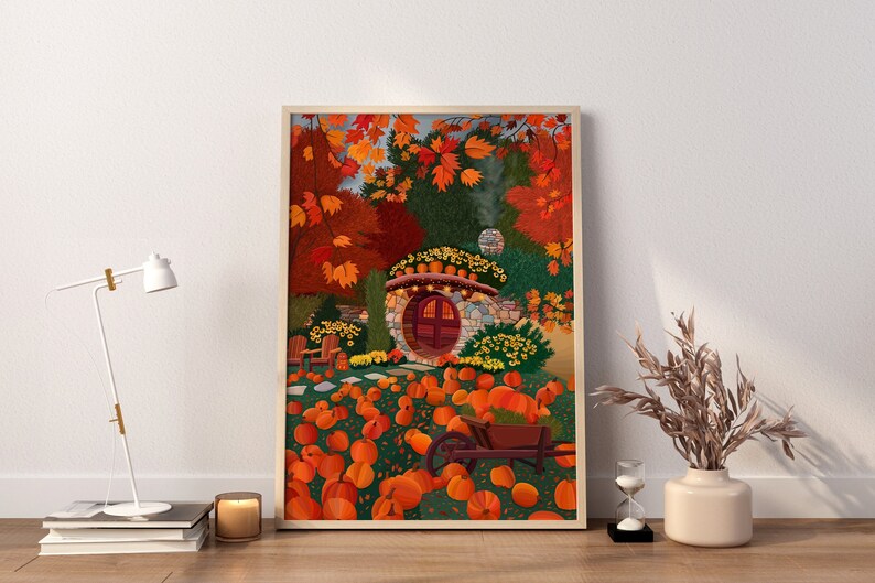 May include: A whimsical illustration of a stone cottage with a round door surrounded by pumpkins and autumn leaves. The cottage is nestled in a forest setting with a wheelbarrow filled with pumpkins in the foreground.