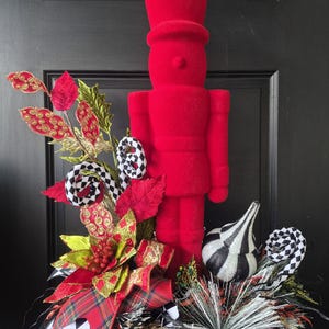 Flocked Nutcracker Centerpiece: Red and Green Gem Picks, Velvet Leaves, Tartan Plaid Bow