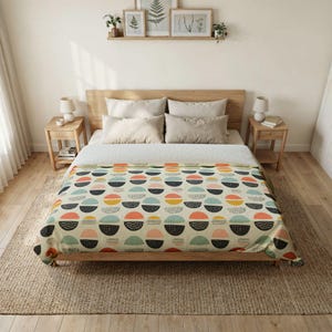 May include: A beige duvet cover with a repeating pattern of colorful semi-circles. The semi-circles are in shades of coral, yellow, blue, and black, with dotted and striped details. The duvet is on a wooden bed frame.