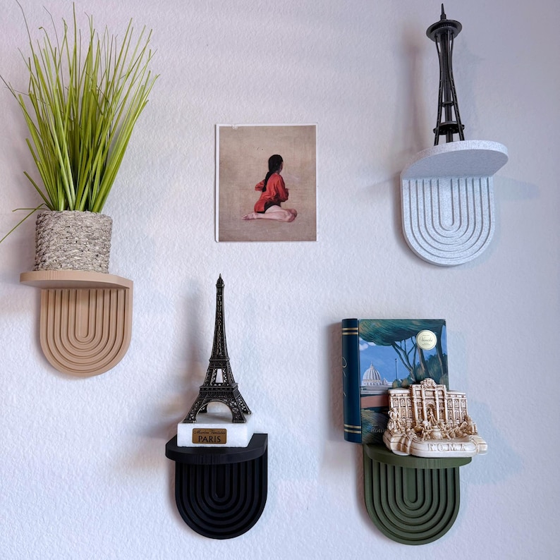 a set of mini wall hanging shelves with a modern ribbed arched design, shown in a variety of colors. The shelves hold small items.