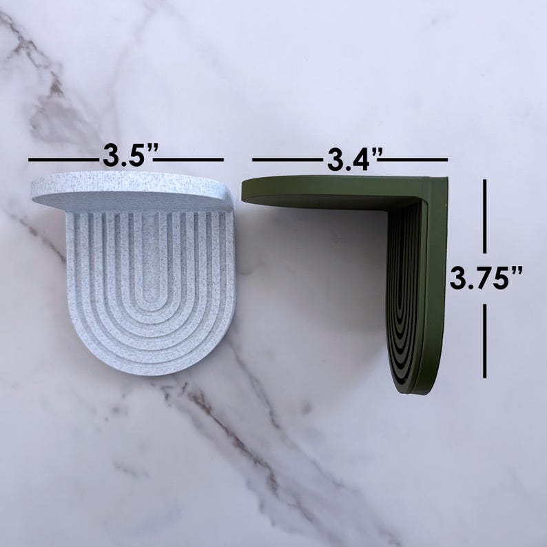 a set of mini wall hanging shelves with a modern ribbed arched design, shown in a variety of colors. the shelves are about 3.5 inches on all sides.